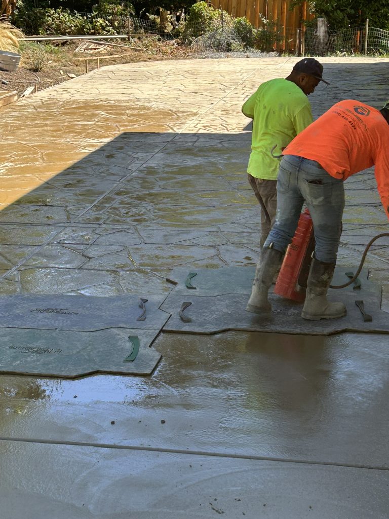 Crew finishing a new concrete driveway in Portland