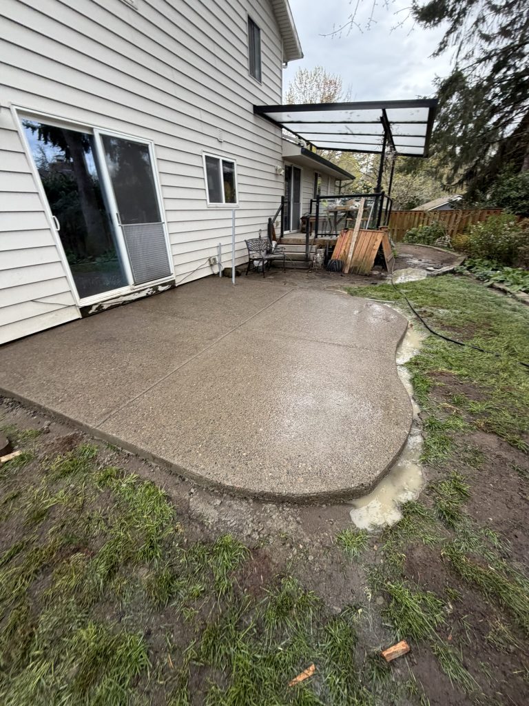 Curved concrete patio built behind a Portland home